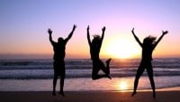 3_people_jumping_beach_sunset